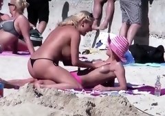 Voyeur films two hot babes rubbing sunscreen on each other